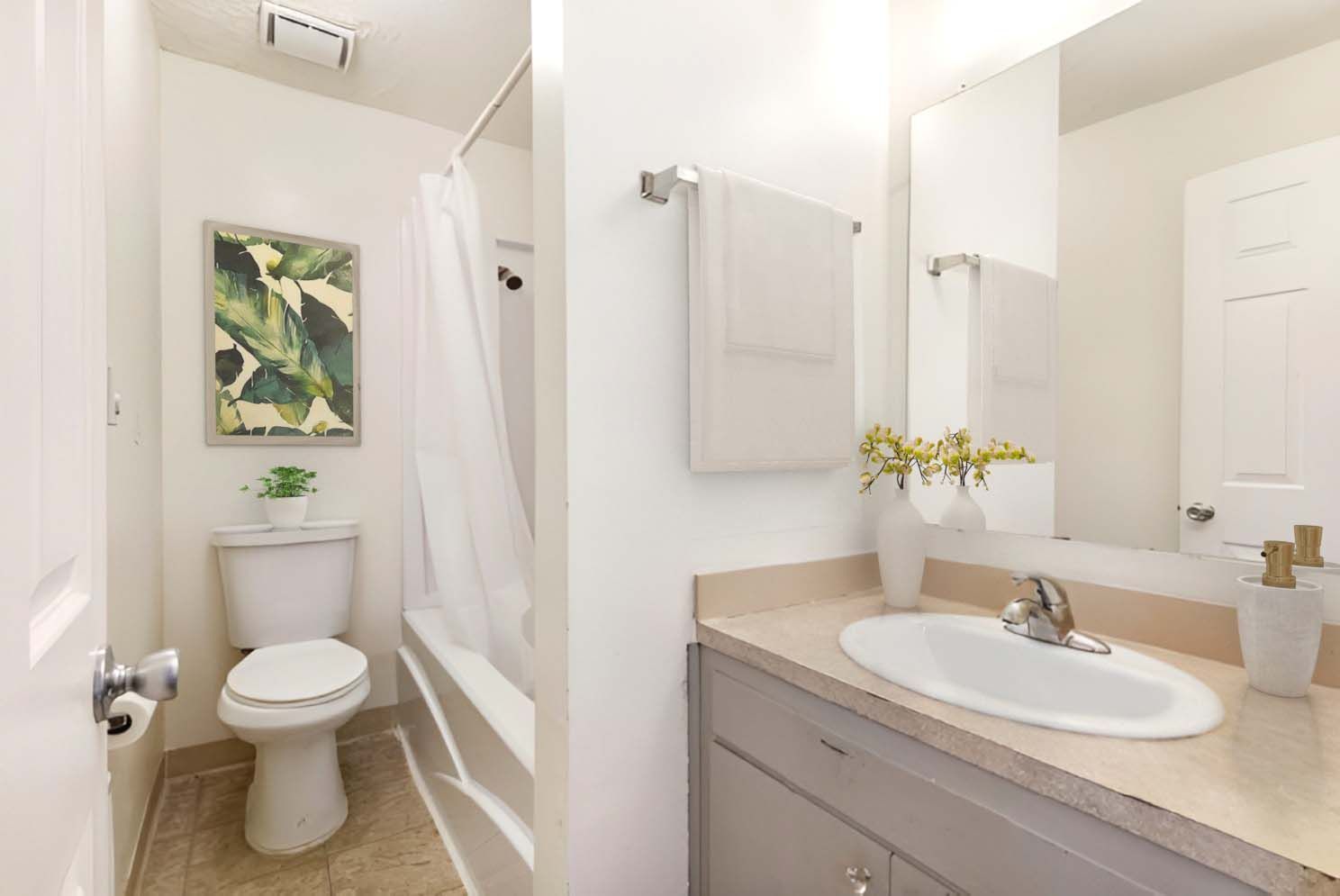 A bathroom with a toilet , sink , and bathtub.