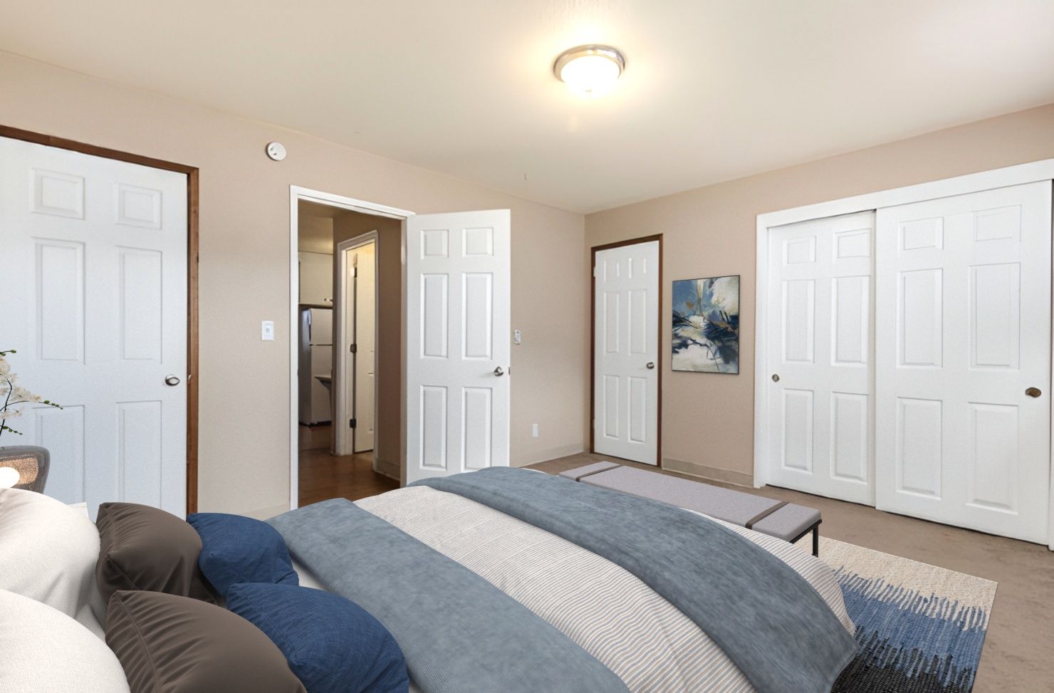 A bedroom with a bed , closets and a walk in closet.