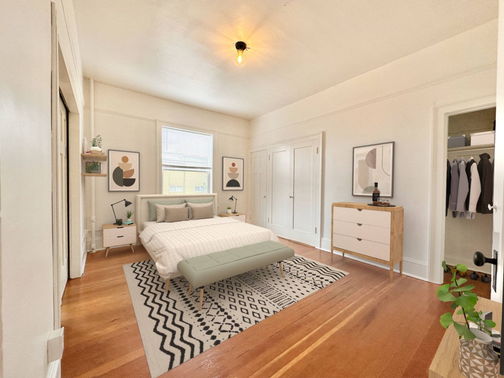 A bedroom with a large bed and a walk in closet.