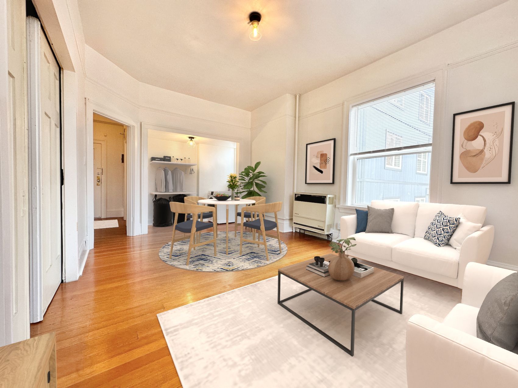 A living room with a couch , chair , coffee table and dining table.