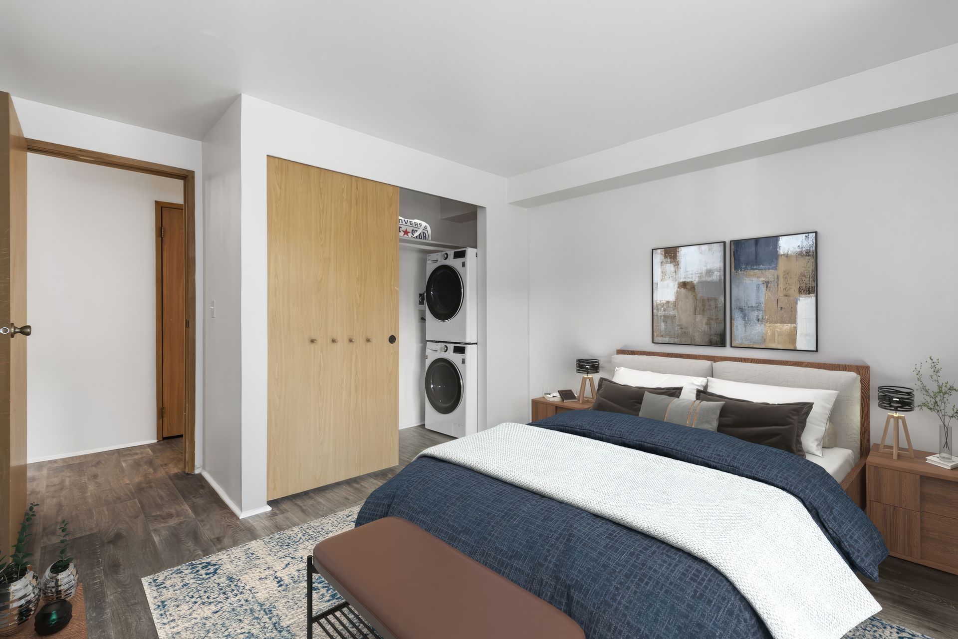 An artist 's impression of a bedroom with a washer and dryer.