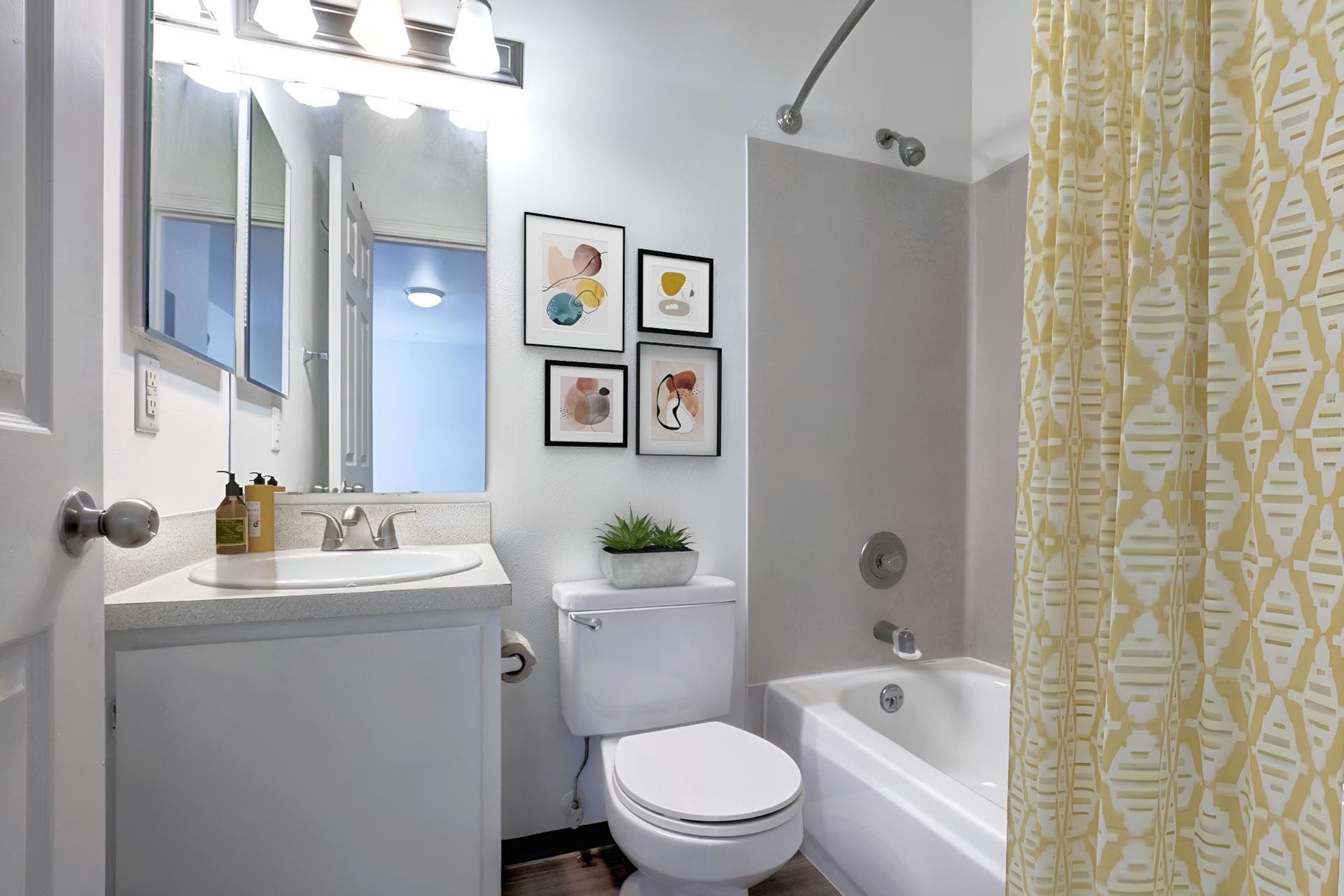 A bathroom with a toilet , sink , and bathtub.