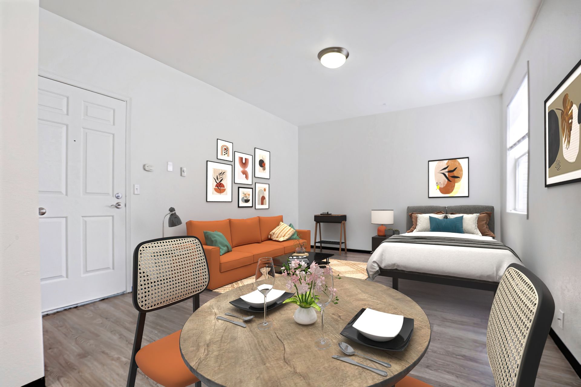 A living room with a couch , table , chairs and a bed.