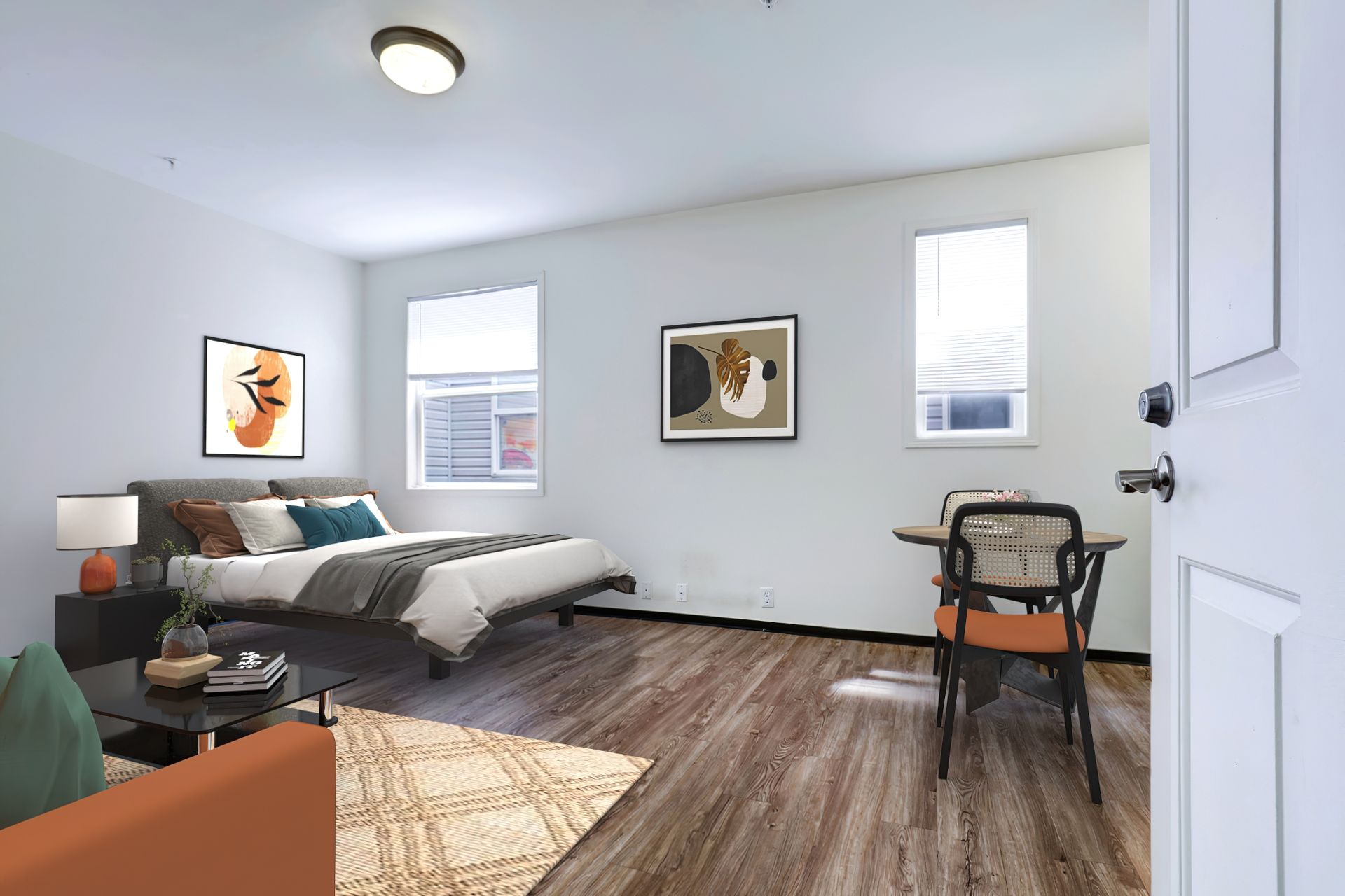 A bedroom with a bed , couch , table and chairs.