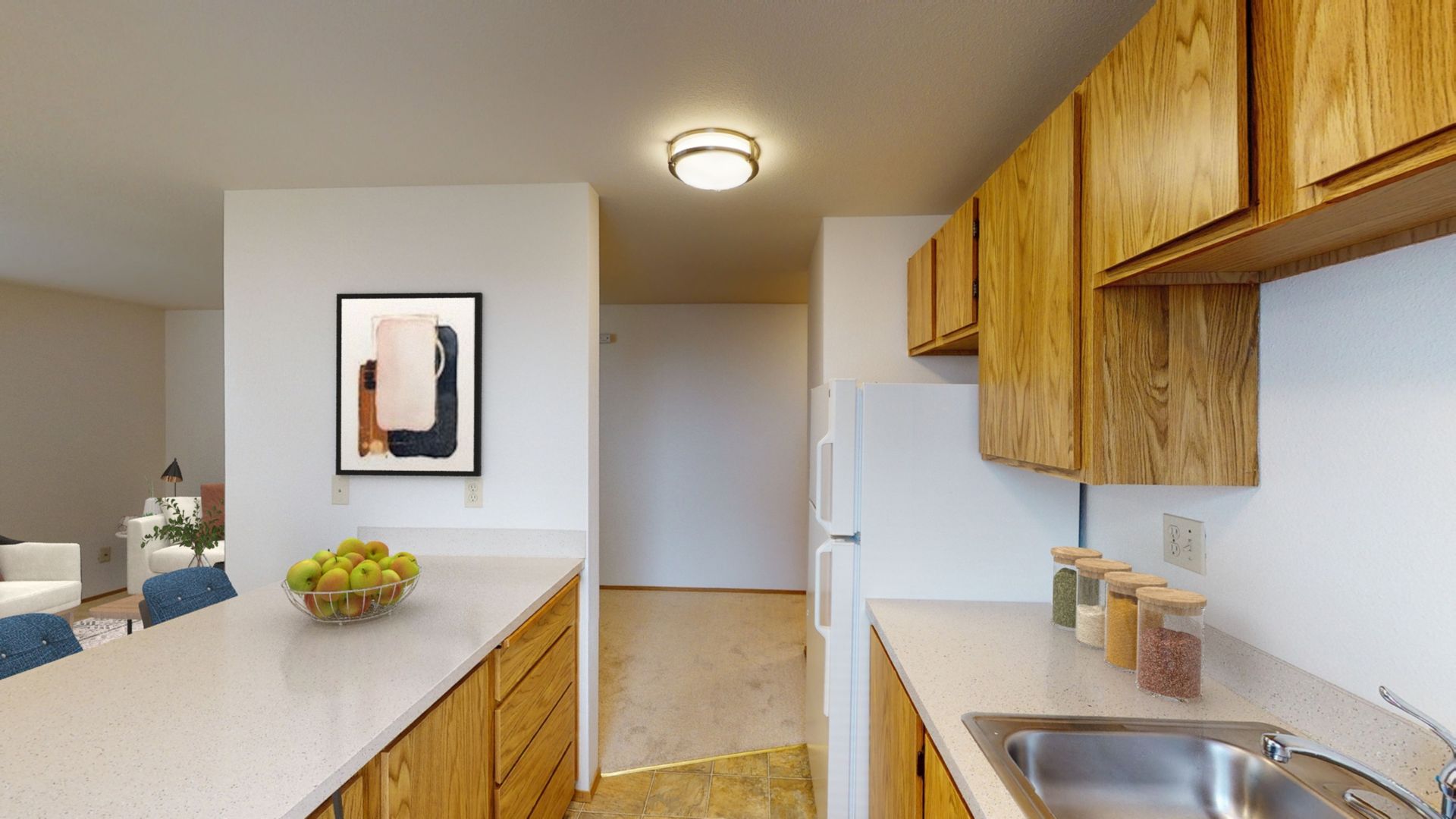 A kitchen with wooden cabinets and a stainless steel sink.