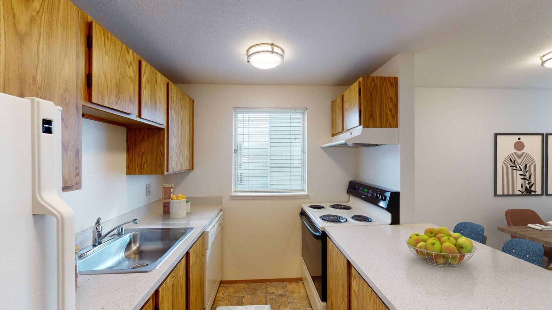 A kitchen with a sink , stove , refrigerator and dishwasher.