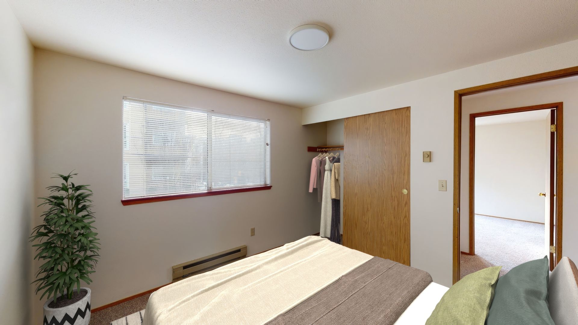 A bedroom with a large bed and a window