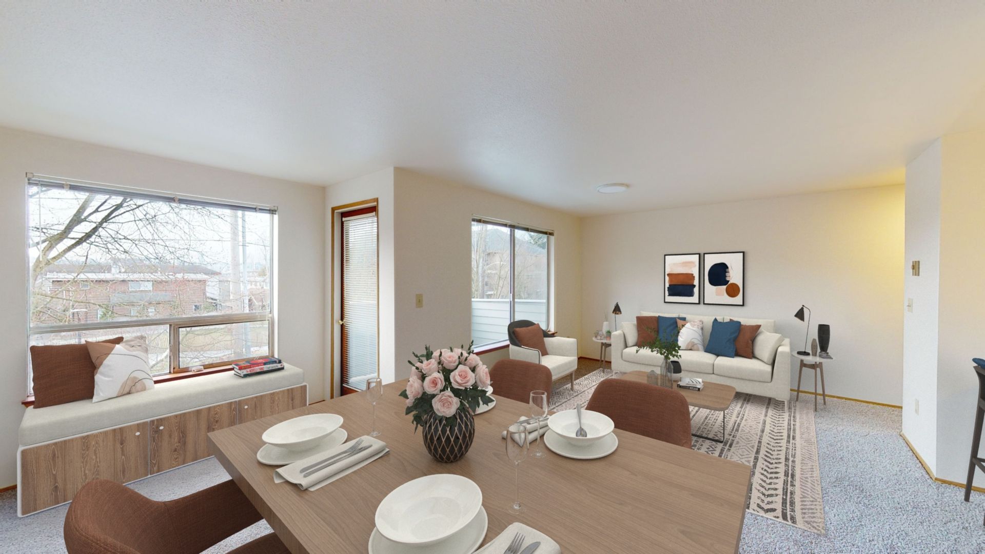 A living room with a dining table and chairs and a couch.
