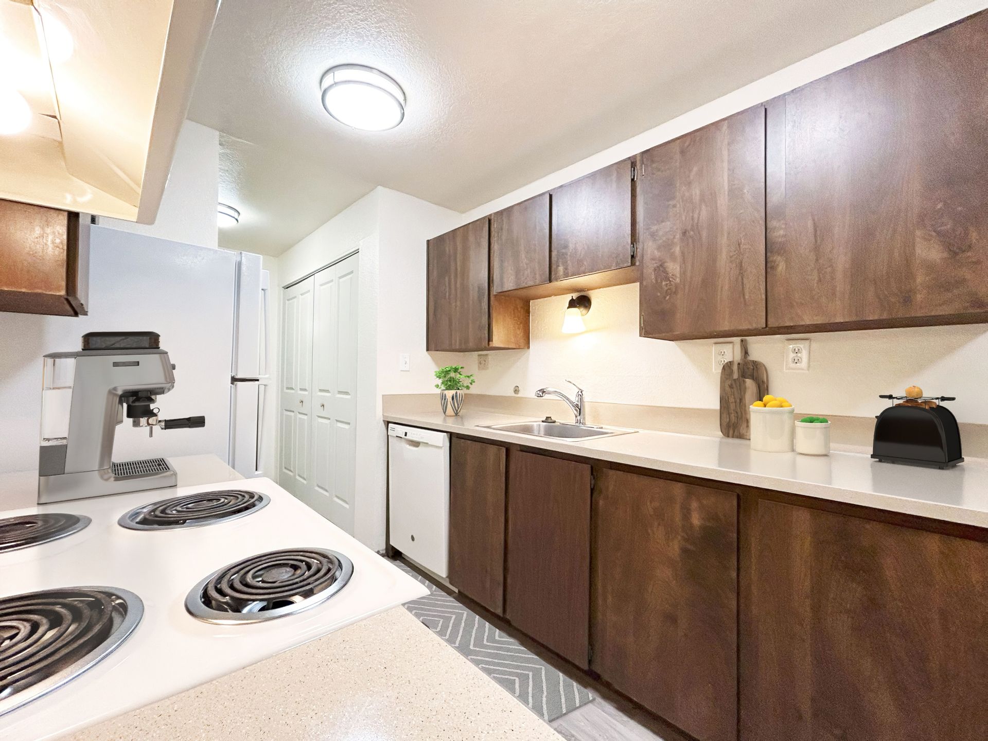 A kitchen with wooden cabinets and a white stove top oven.
