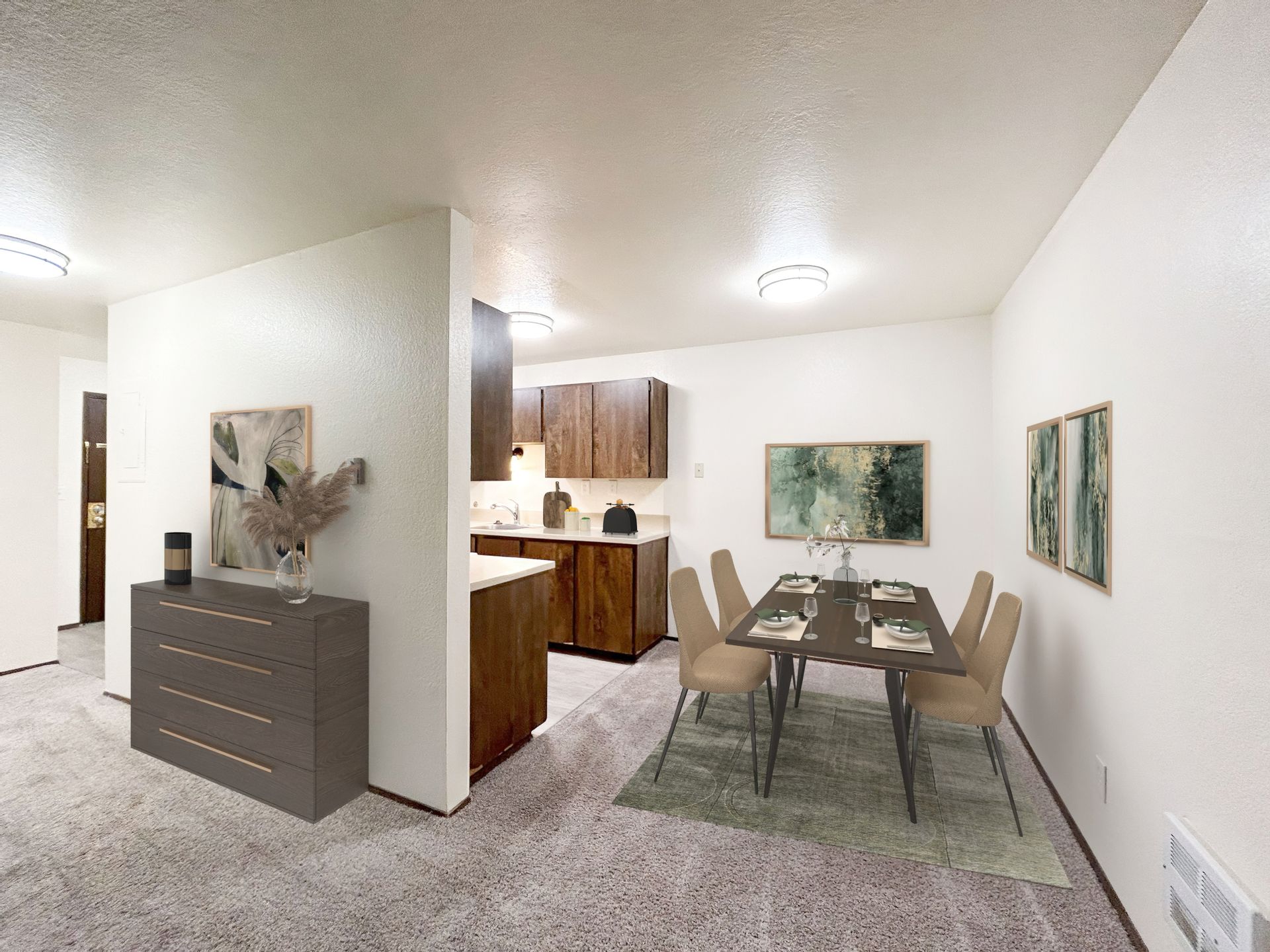 A living room with a dining table and chairs and a kitchen.