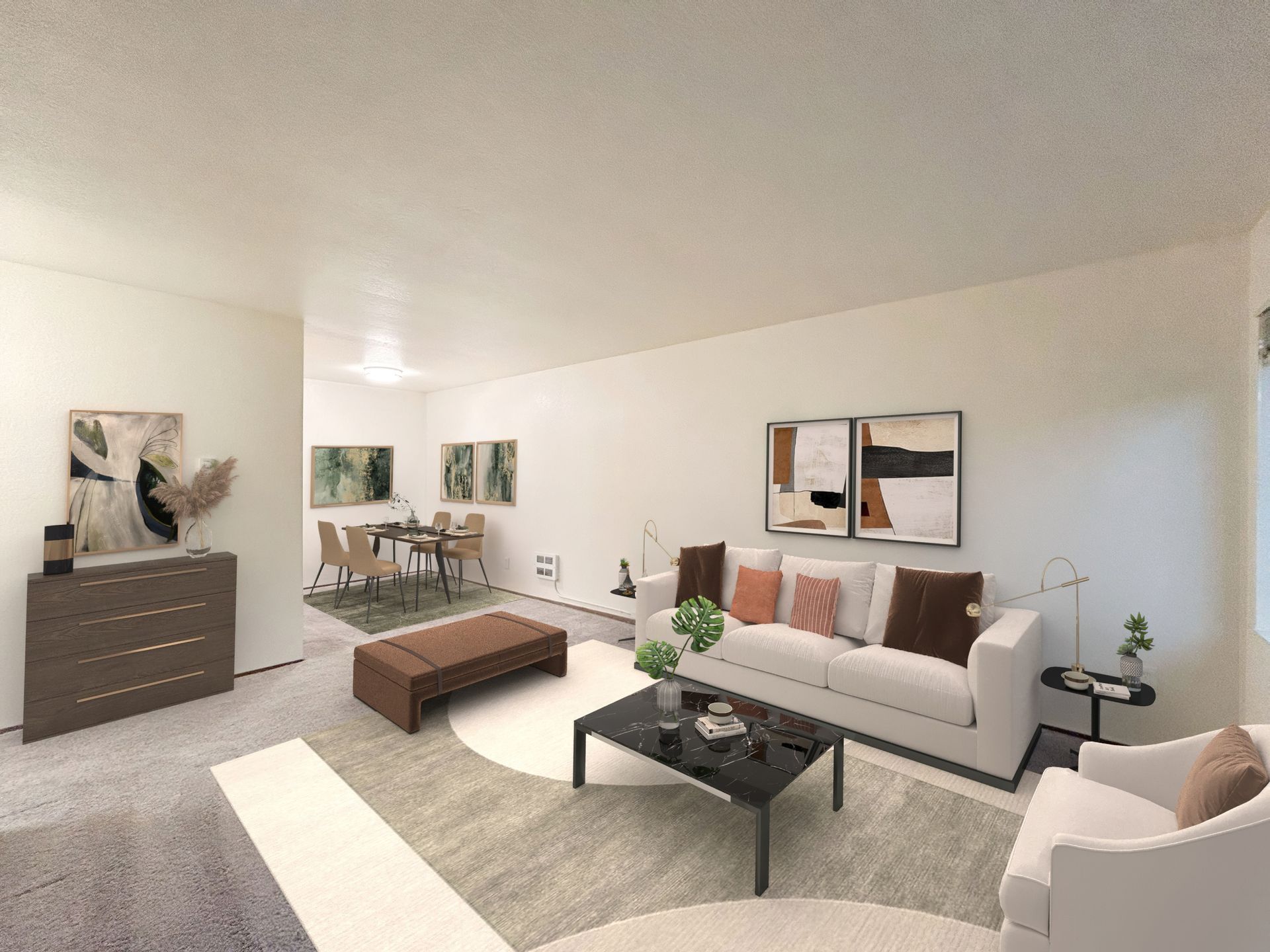 A living room with a couch , chair , coffee table and ottoman.