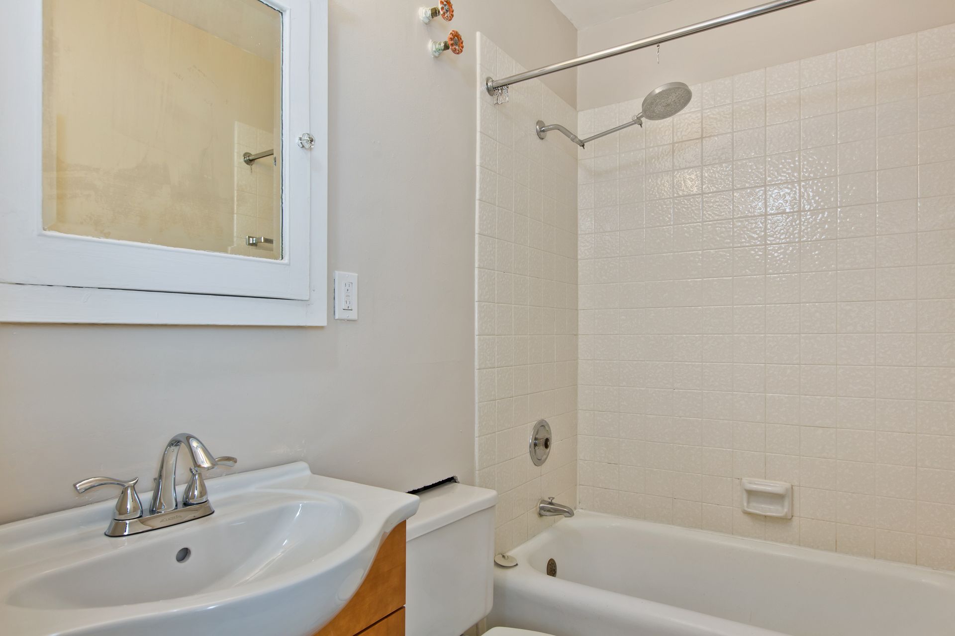 A bathroom with a sink , toilet and bathtub.