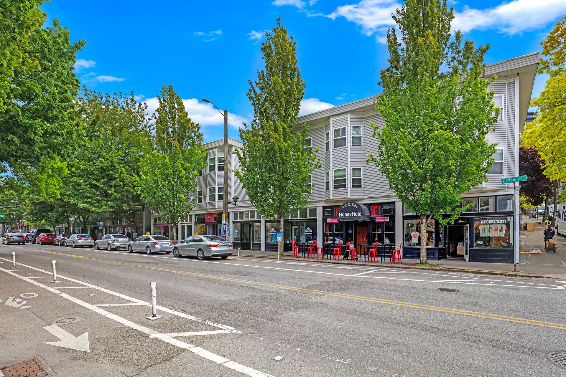 A row of stores are lined up on the side of a city street.