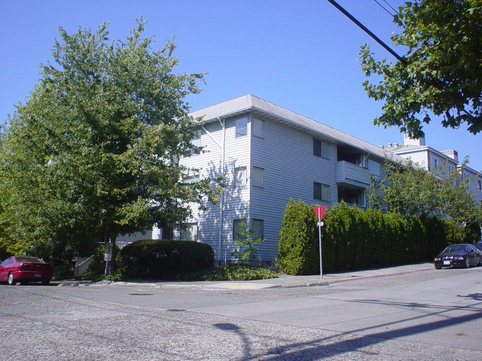 A white building with a red stop sign in front of it