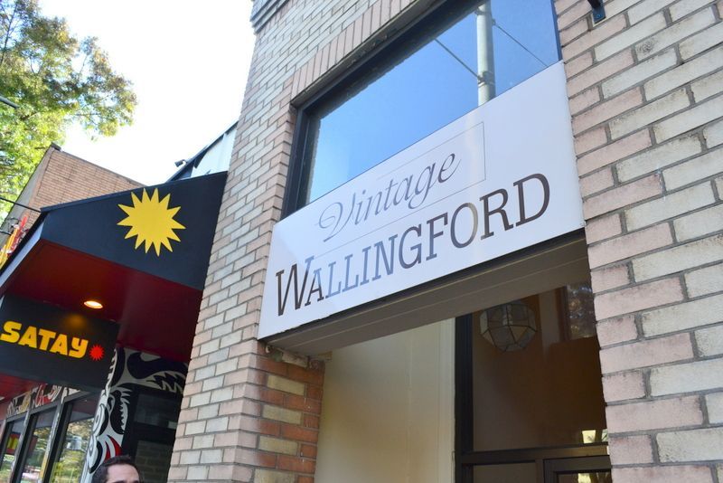 A man stands in front of a vintage wallingford store