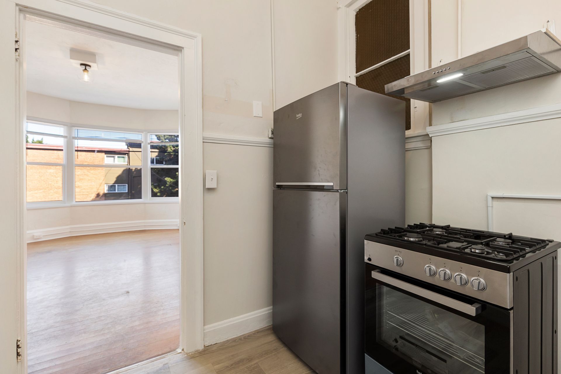 A kitchen with a refrigerator , stove and oven.