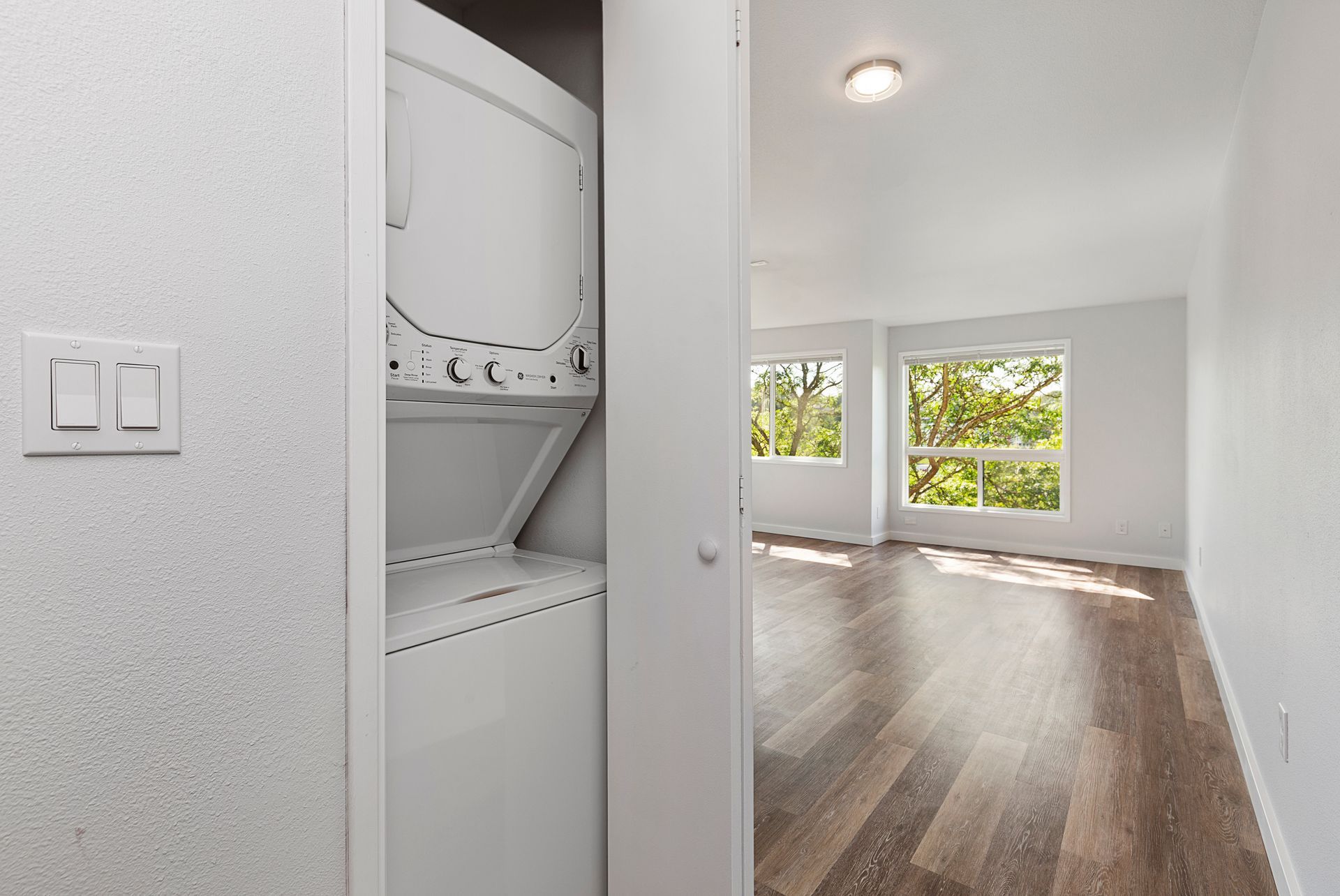 A washer and dryer are stacked on top of each other in a room.