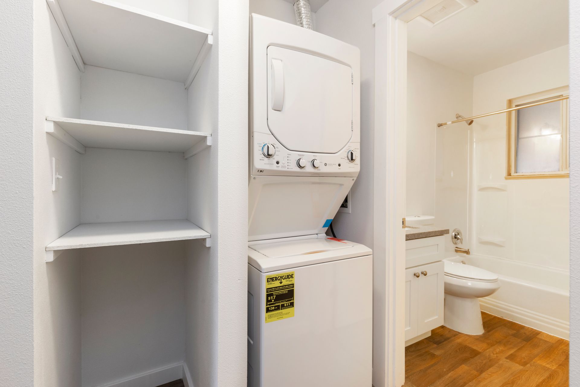 A washer and dryer are stacked on top of each other in a bathroom.