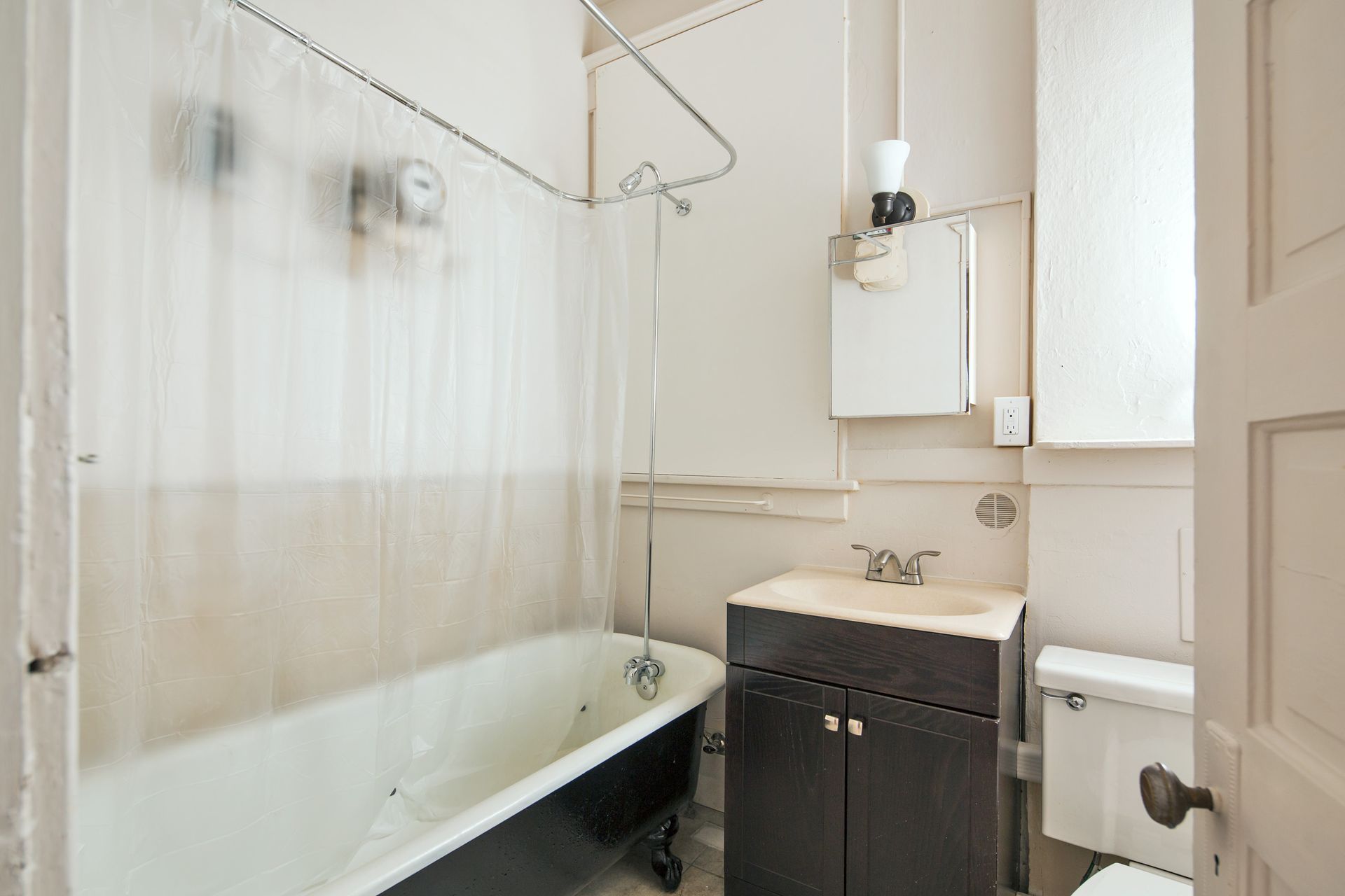 A bathroom with a bathtub a sink and a toilet