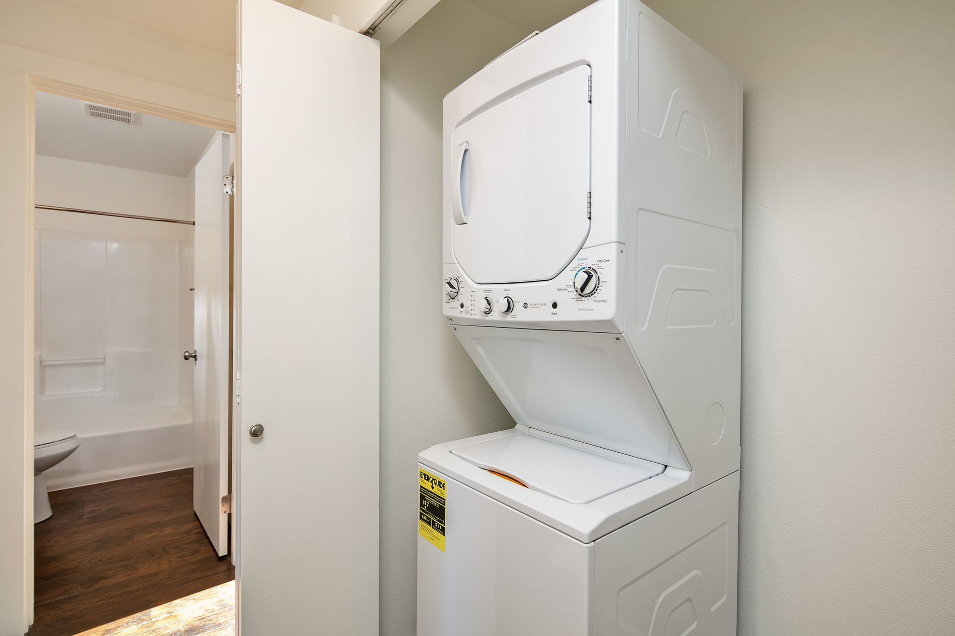 A washer and dryer are stacked on top of each other in a bathroom.