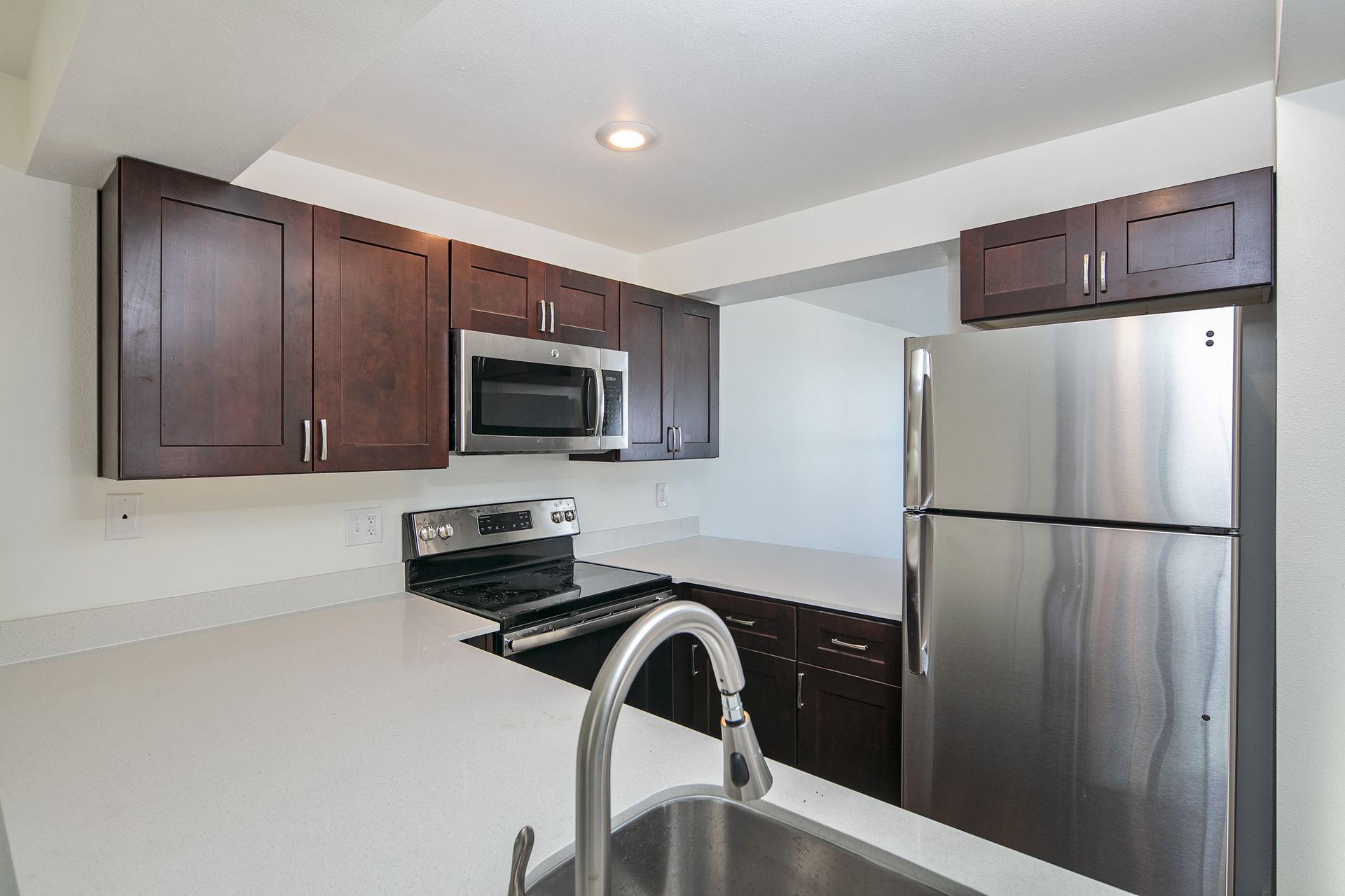 A kitchen with stainless steel appliances and wooden cabinets