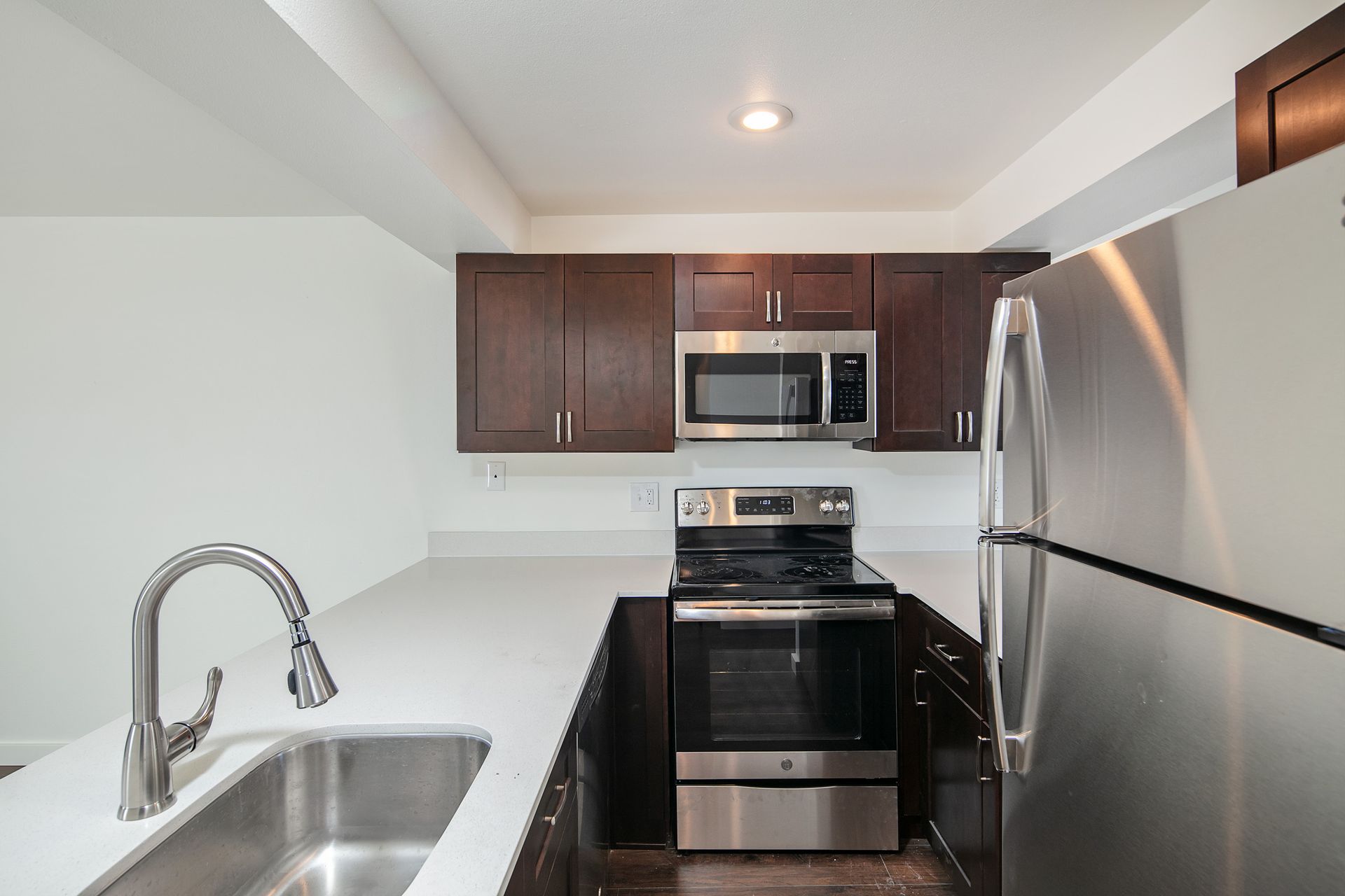 A kitchen with stainless steel appliances and a sink