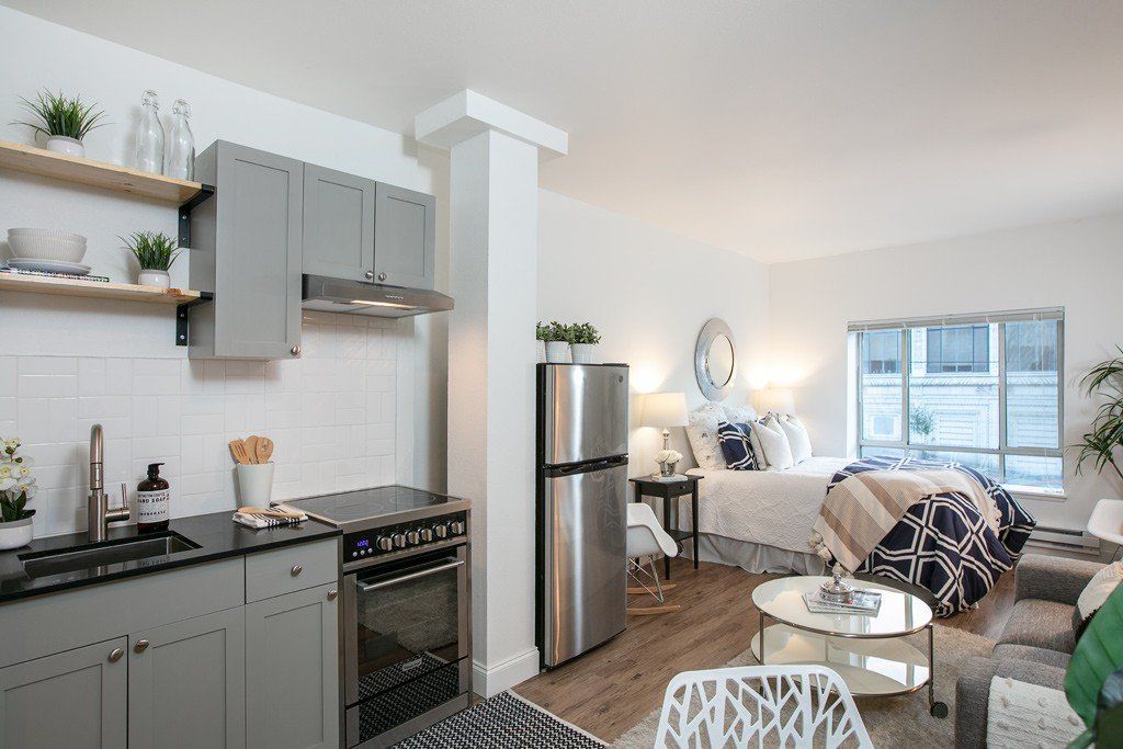 A kitchen with stainless steel appliances and a stainless steel refrigerator
