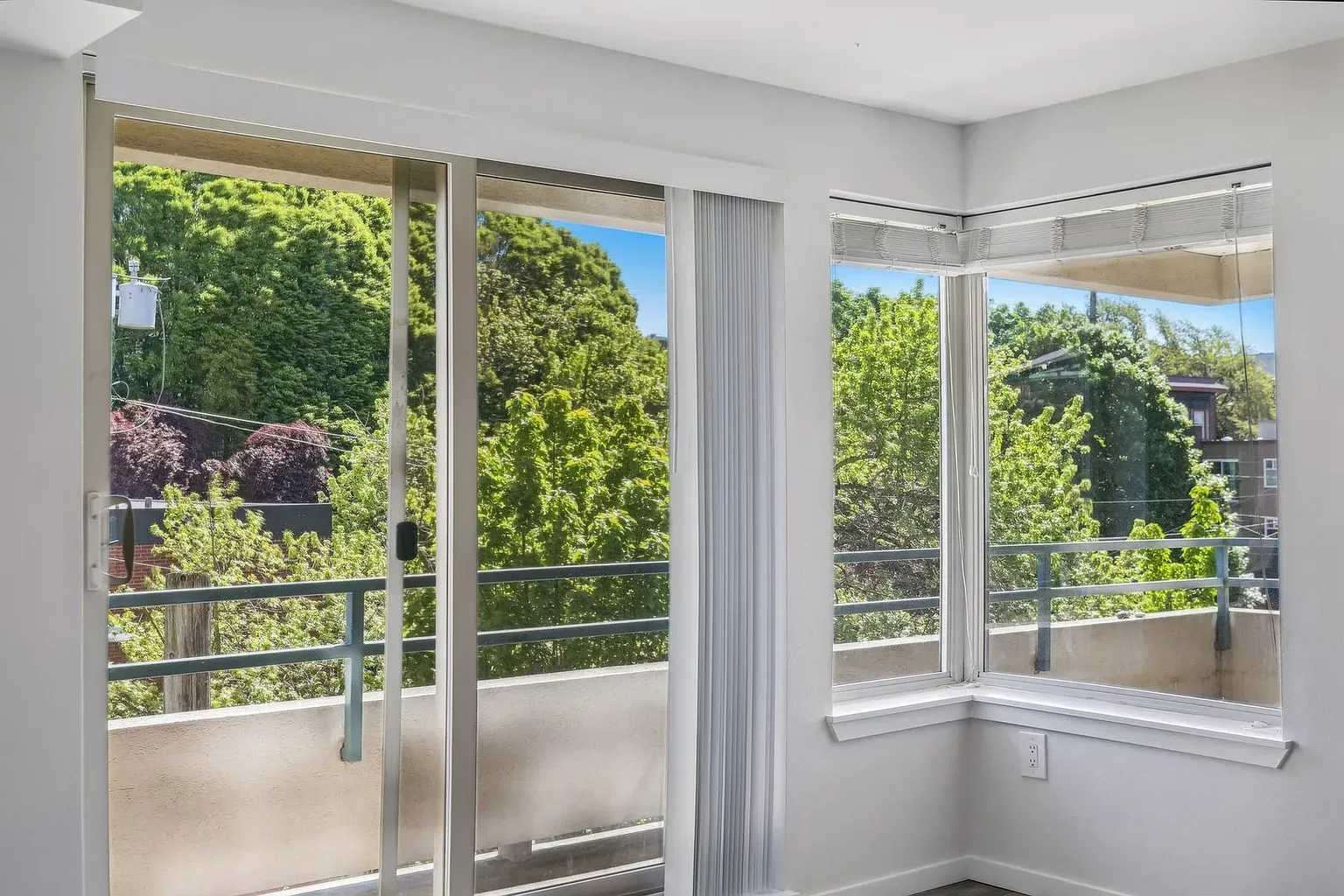 A living room with a sliding glass door leading to a balcony.