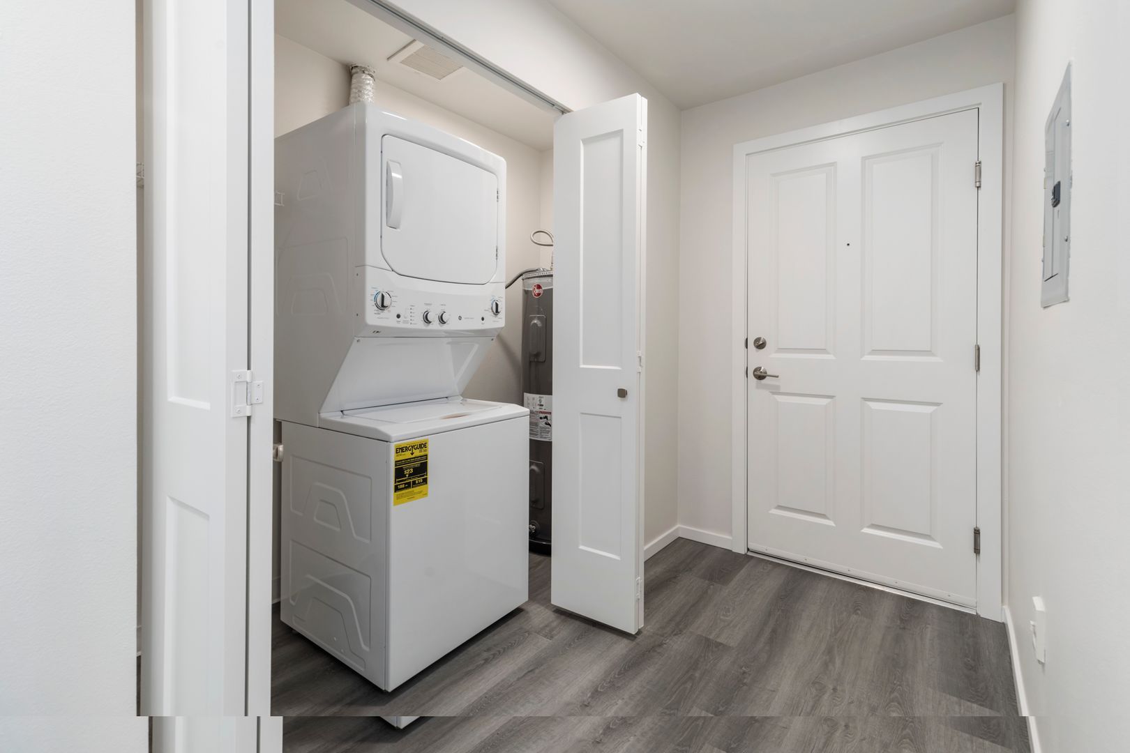 A washer and dryer are stacked on top of each other in a laundry room.