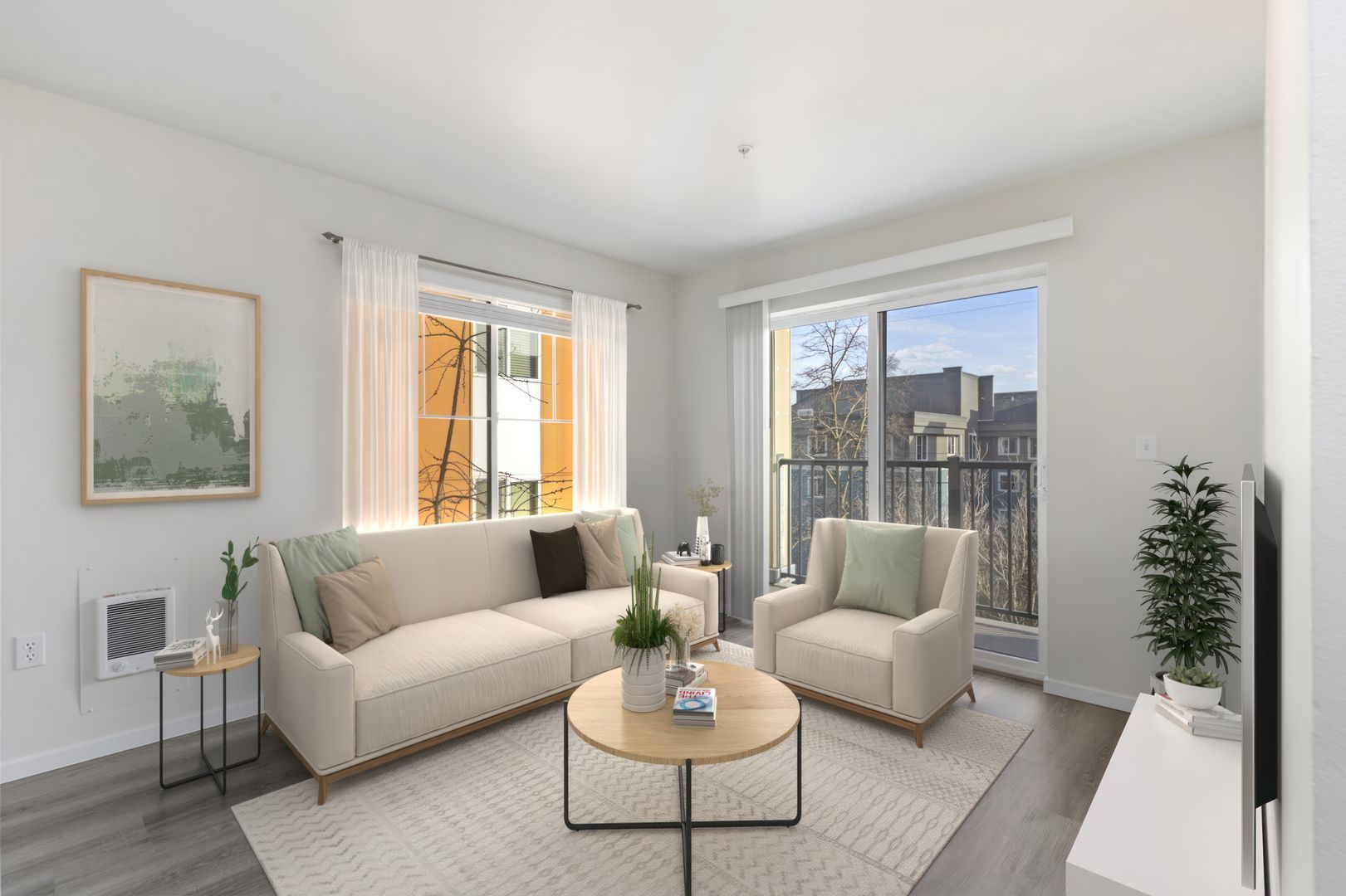 A living room with a couch , two chairs , a coffee table and a balcony.
