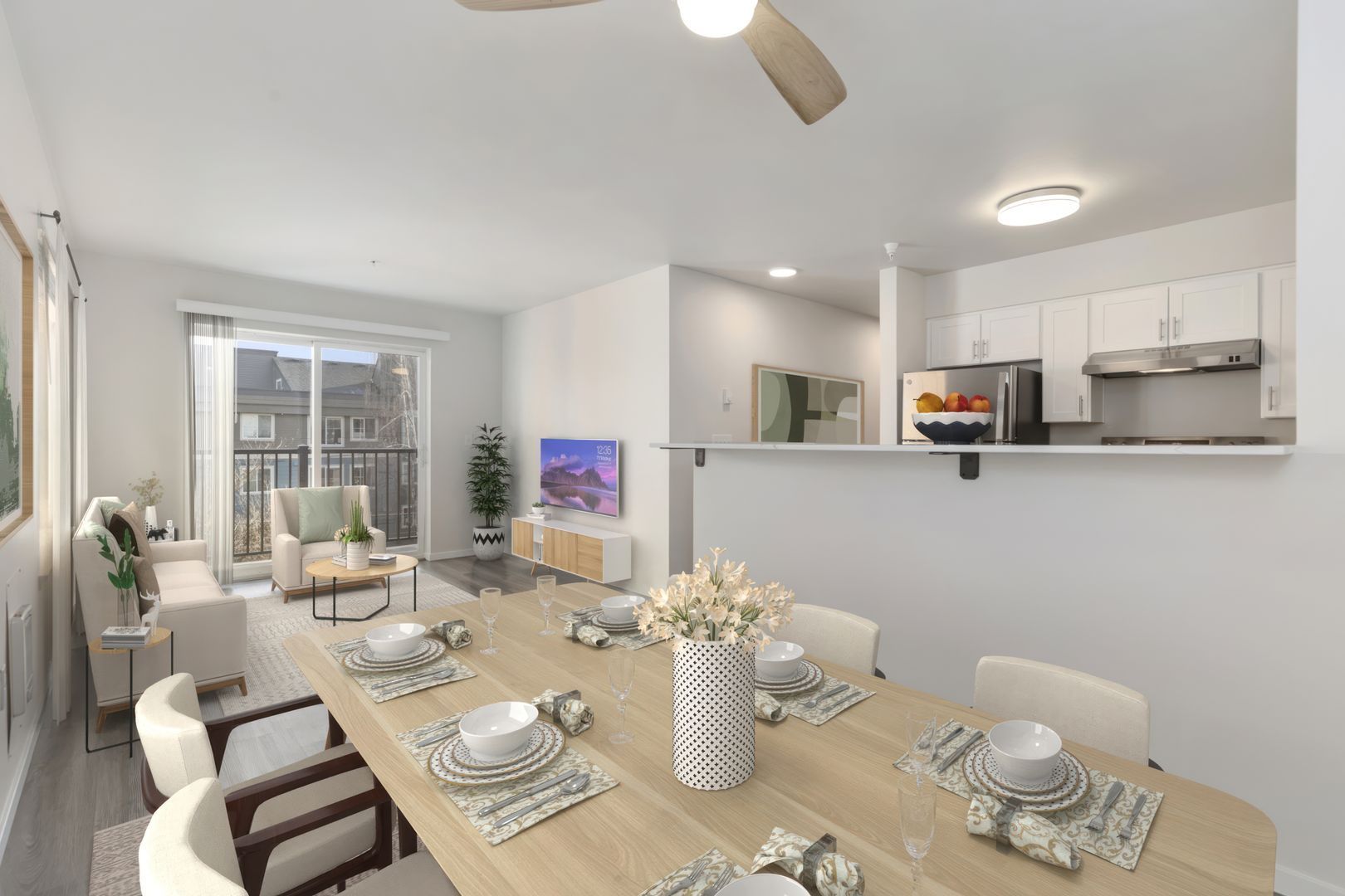 A living room with a dining table and chairs and a ceiling fan.