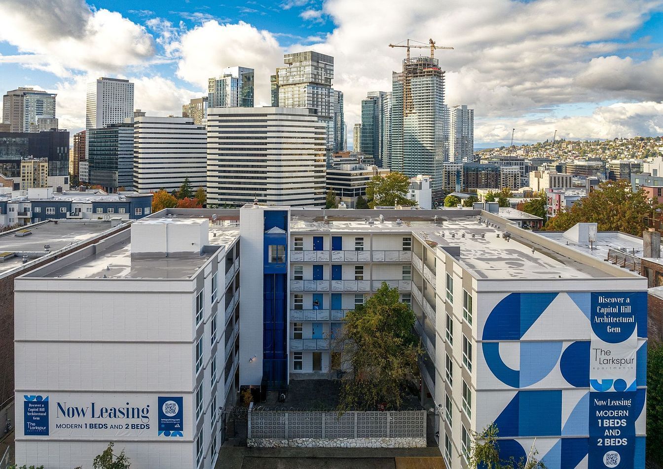An aerial view of a building with blue and white geometric designs on it