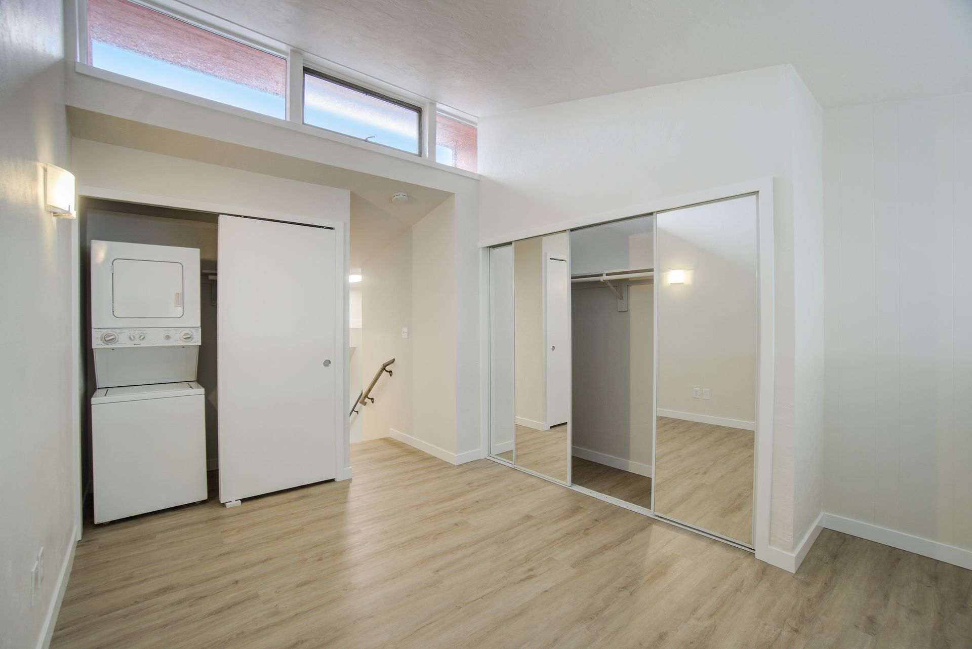 There is a washer and dryer in the corner of the room.