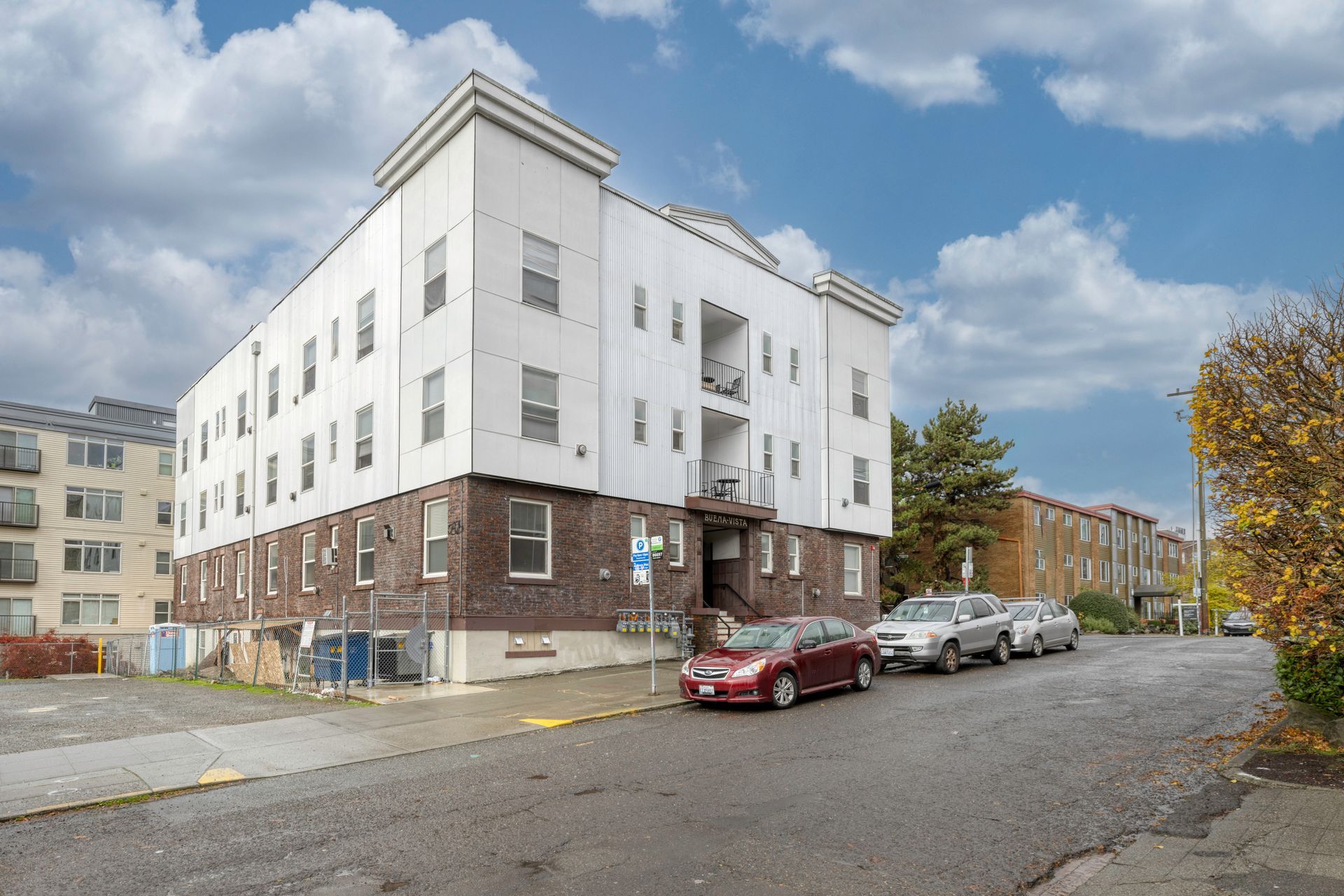 A large apartment building with stairs leading up to the entrance