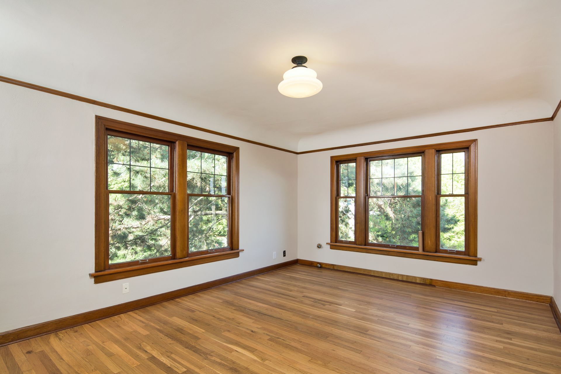 A living room with a dining table and chairs and a kitchen in the background.
