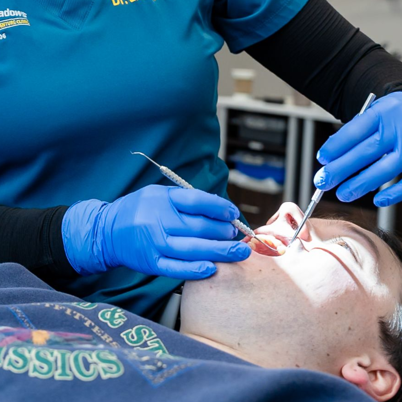 Dental hygienist cleaning a patient’s teeth