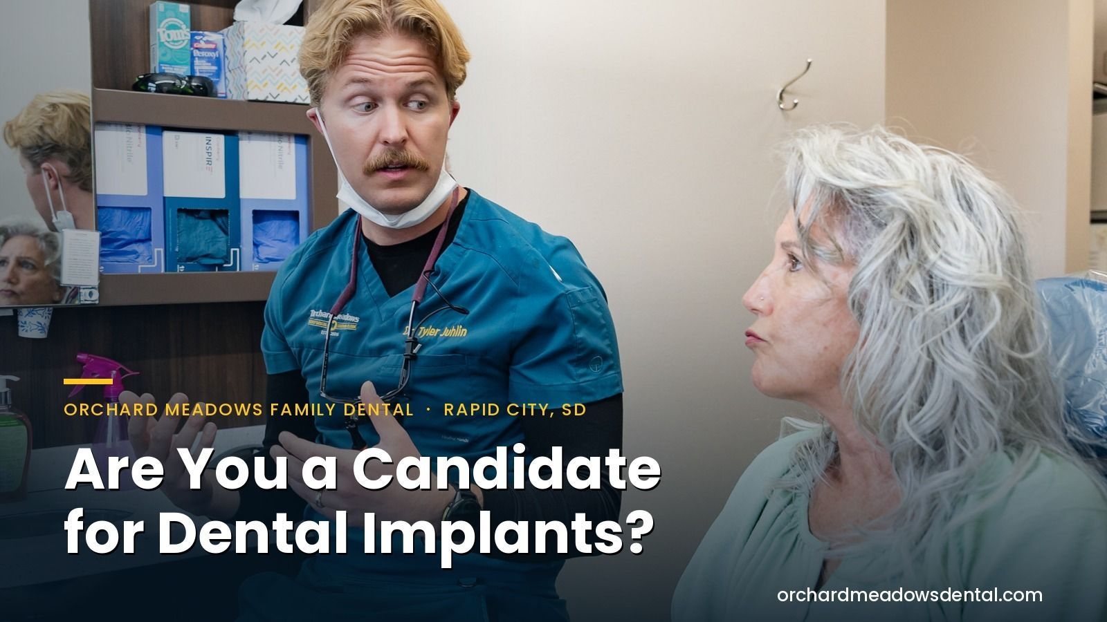 A dentist reviewing a dental implant treatment plan with a patient at Orchard Meadows in Rapid City, SD.