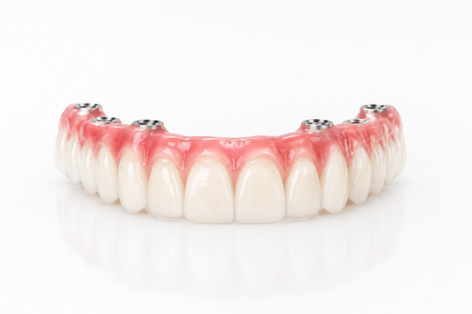 Upper denture with pink gums and white teeth on a white background