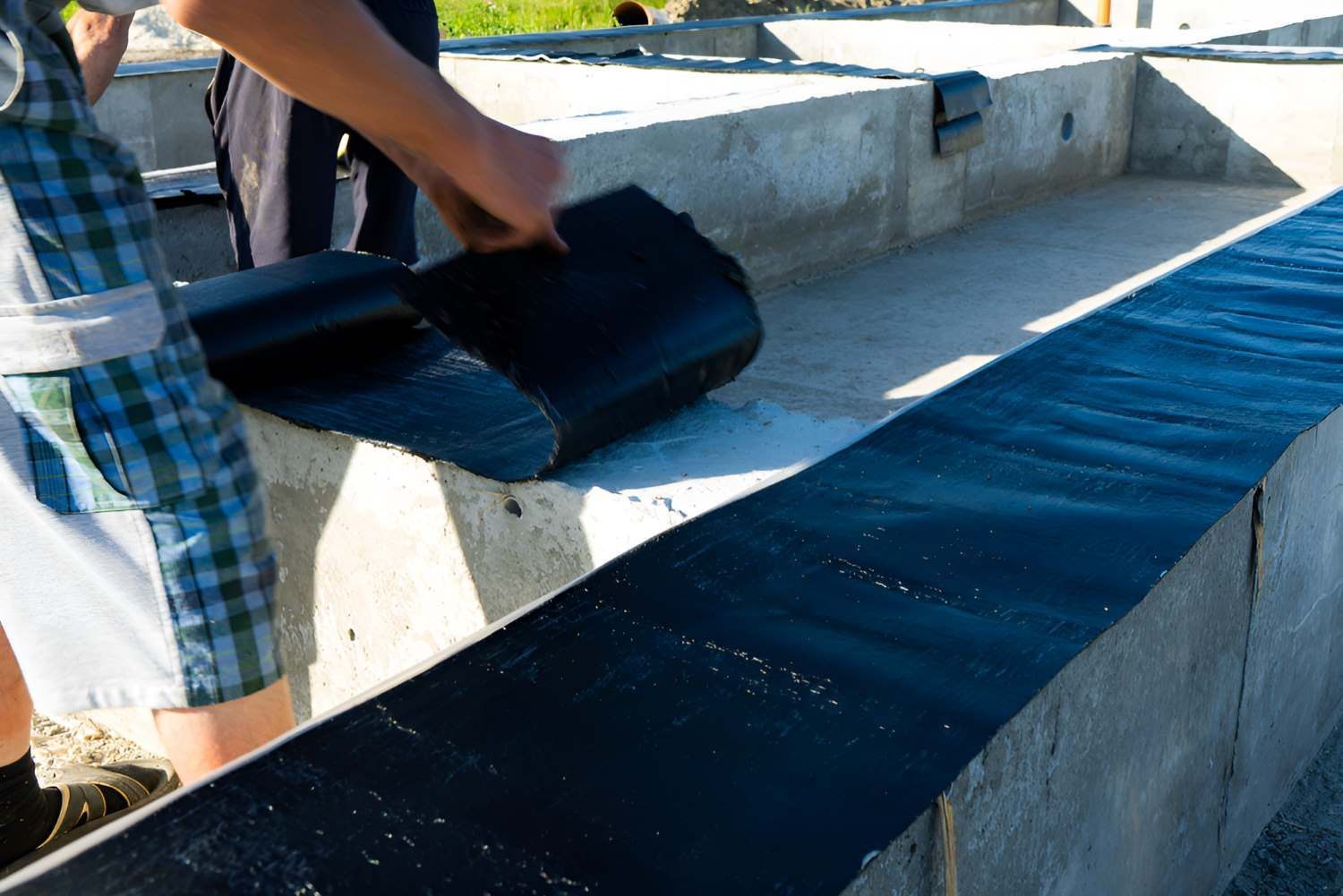 Workers Are Applying Waterproofing To The Foundation — Bananacoast Waterproofing in Korora, NSW