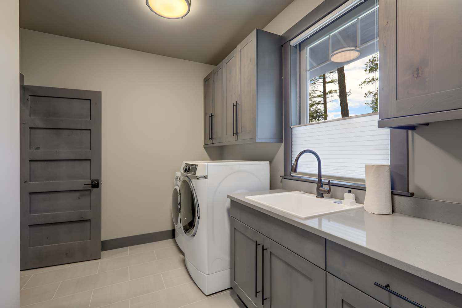 Beautiful Laundry Room With Rish Wooden Doors And White Washer — Bananacoast Waterproofing in Korora, NSW