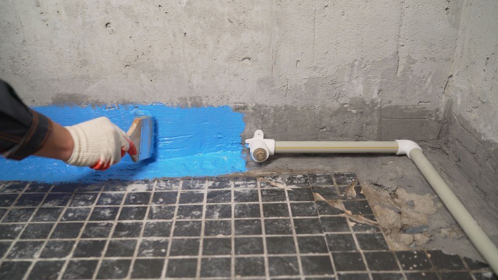 Treating The Bathroom With Blue Waterproofing — Bananacoast Waterproofing in Yamba, NSW