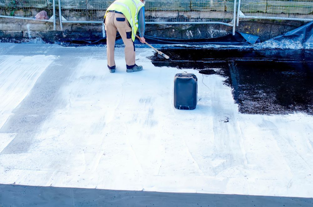 Man Applying Waterproofing In The Slab Flooring — Bananacoast Waterproofing in Bellingen, NSW