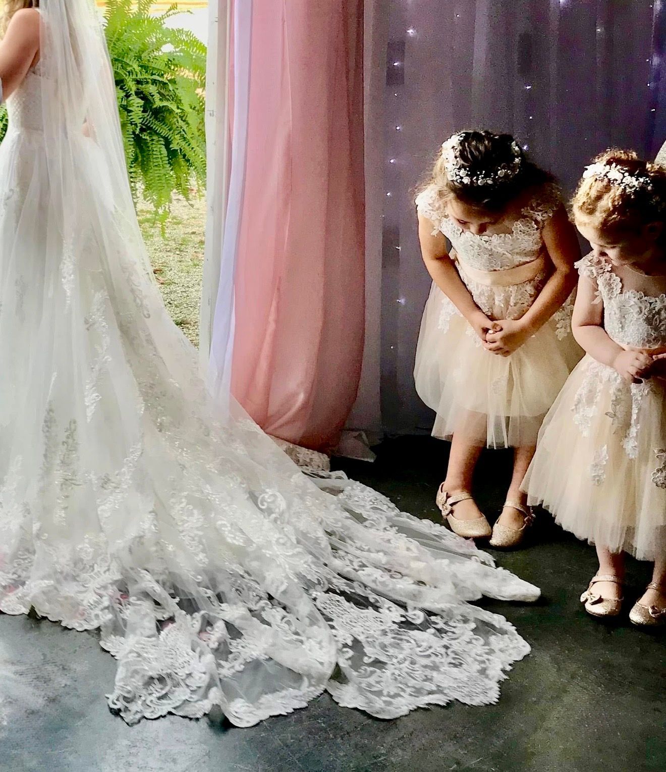 flower girls looking at bride