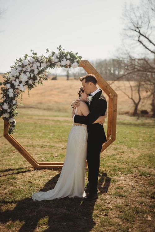 bride and groom hugging