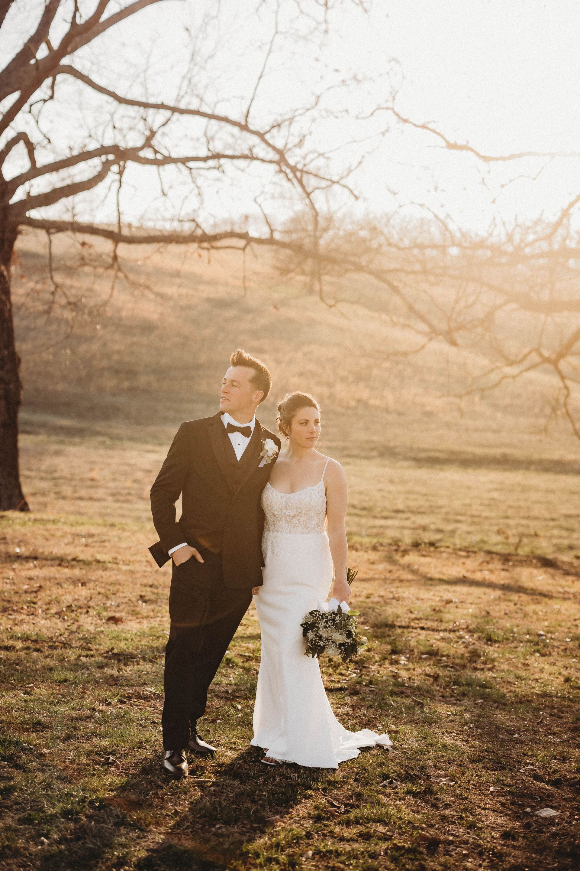 bride and groom standing on scenic hillside