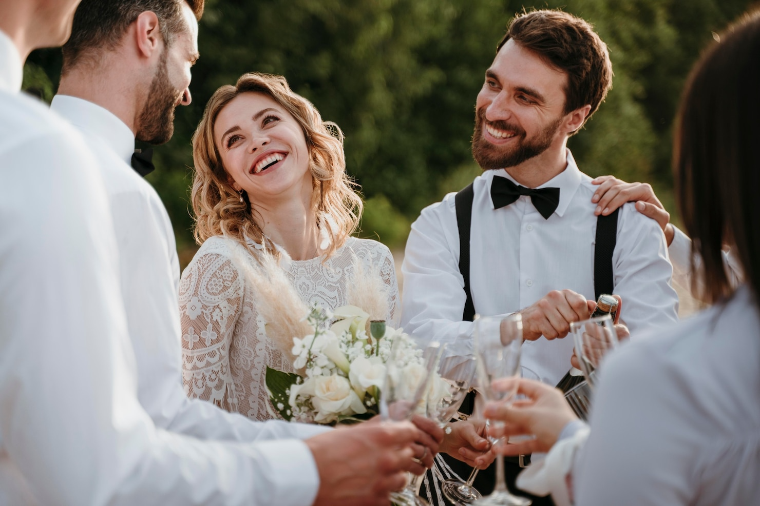 A bride and groom are talking to their wedding guests at their wedding reception.