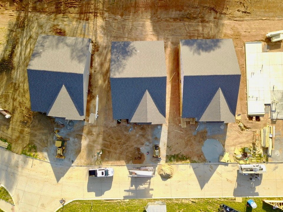 An aerial view of a row of houses under construction