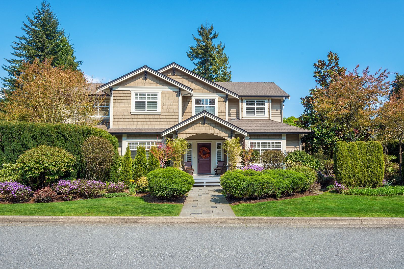 craftsman house with beautiful landscaping in the front yard
