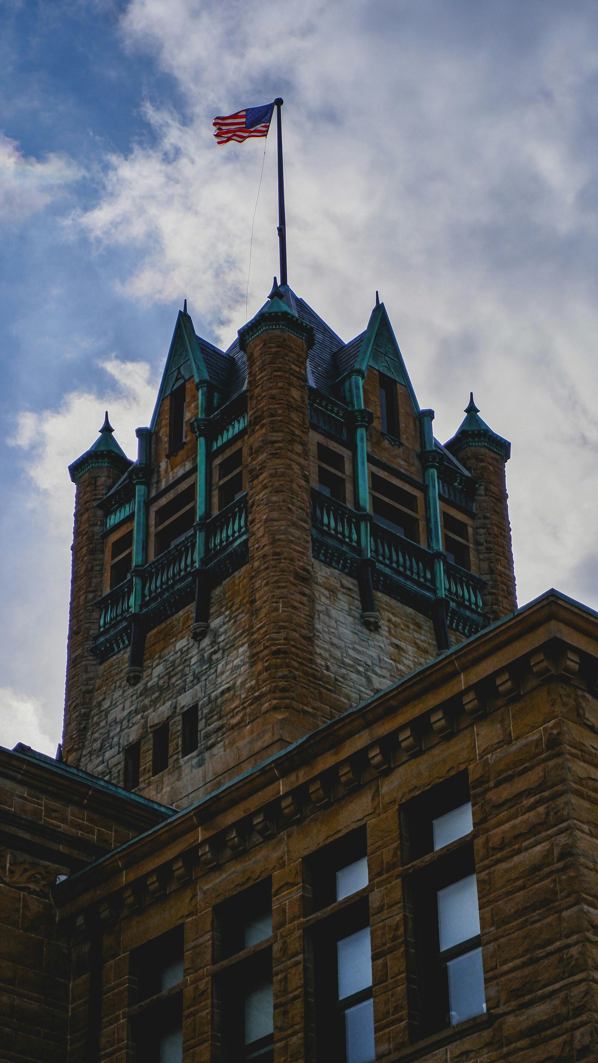 Stone building with oxidized copper roof in Olathe, KS for commercial cleaning and janitorial services