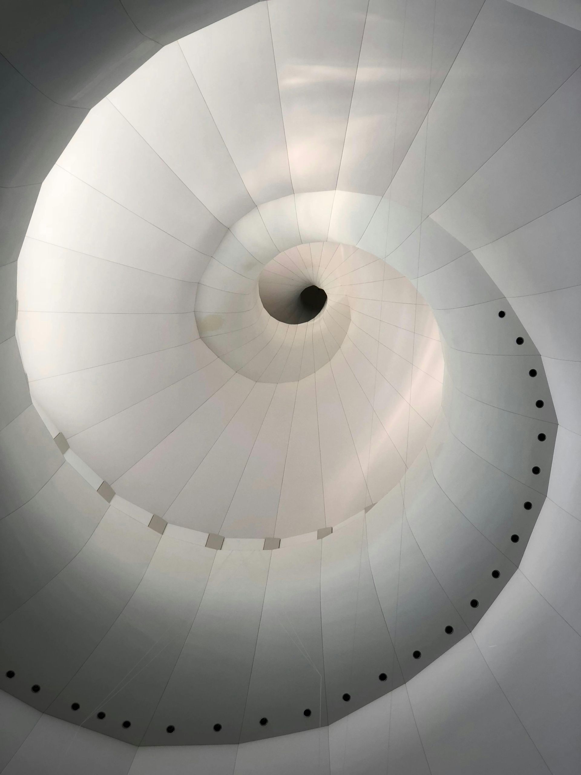 Modern spiral architectural ceiling with curved white panels Representing commercial and janitorial cleaning done in Missouri